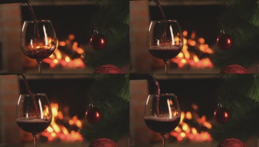 在燃烧的壁炉的背景下，葡萄酒倒进玻璃杯高清在线视频素材下载