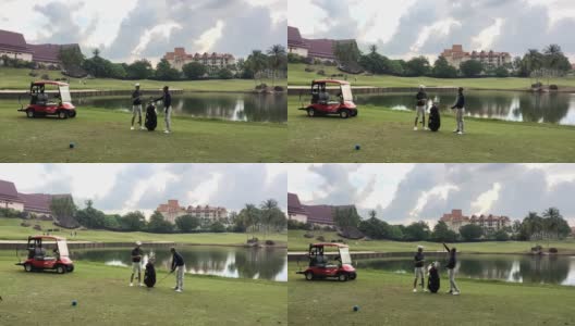 亚洲华人成年人从高尔夫球袋中挑选高尔夫球棒，并在高尔夫球场开球点指导教儿子高清在线视频素材下载