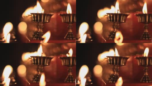 寺庙牛油灯节上的佛坛蜡烛视频。在金属容器中祈祷的油灯和摇曳的火焰，宁静的风景高清在线视频素材下载