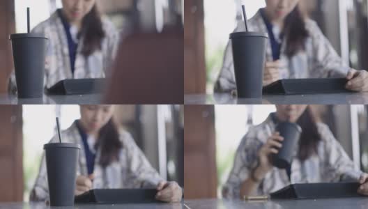 低角度拍摄的年轻亚洲女人喝从旅行杯高清在线视频素材下载