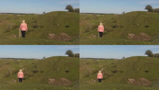在瑞典Skåne，一个女人在徒步旅行途中穿过令人惊叹的风景高清在线视频素材下载