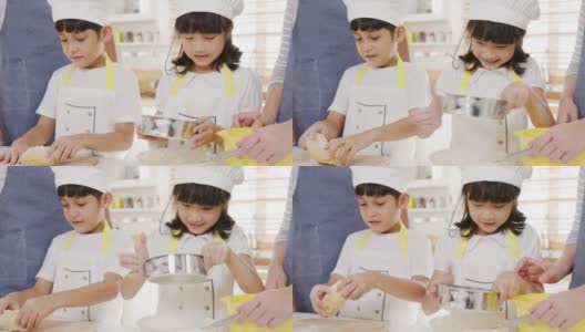 快乐微笑的年轻亚洲日本家庭与学龄前的孩子有乐趣在现代厨房家庭的早餐烘焙糕点或派。高清在线视频素材下载