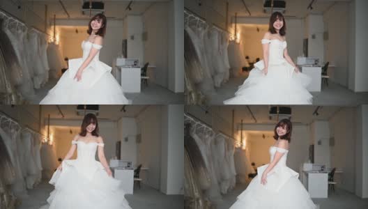 慢动作新娘肖像摆姿势看着相机微笑在婚纱店尝试结婚礼服长大高清在线视频素材下载
