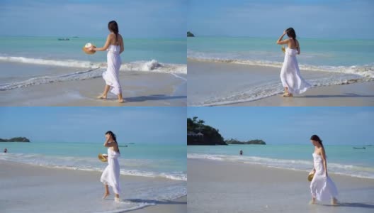 年轻美丽的女人在白色的热带沙滩上高清在线视频素材下载