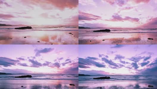 乌云密布的天空在夕阳的最后余晖下，在海面和科门德尔山脉上呈现出粉红色高清在线视频素材下载
