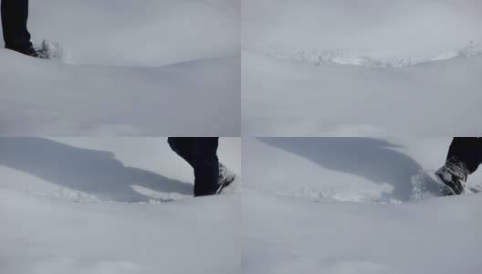 在厚厚的雪堆里行走的人高清在线视频素材下载