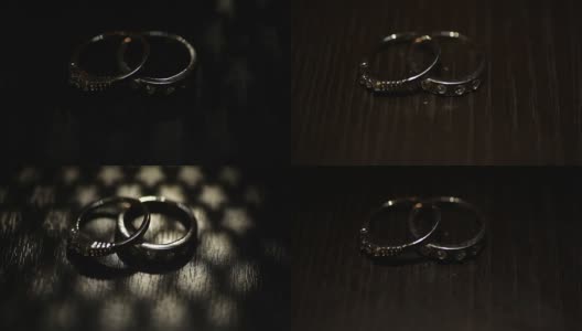 牛皮纸盒子上的两个结婚戒指。黑暗的场景高清在线视频素材下载