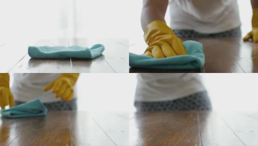 清洁人员用手喷洒清洁木桌，用超细纤维布擦拭高清在线视频素材下载