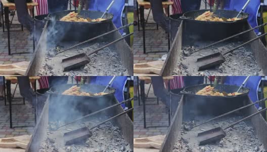 在街头咖啡馆里，一个盛着乌兹别克肉饭的大碗正放在冒烟的炉子上。街头小吃，快餐，街头小吃，好吃，美味高清在线视频素材下载
