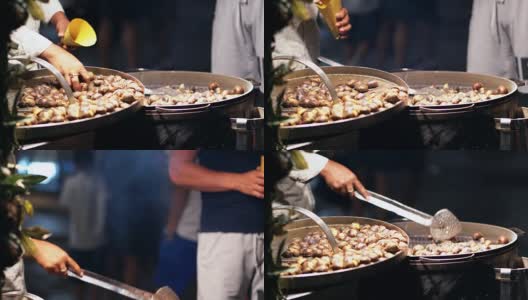 意大利街头快餐。一个街头小贩晚上卖烤栗子。卖烤栗子。4 k (UHD高清在线视频素材下载