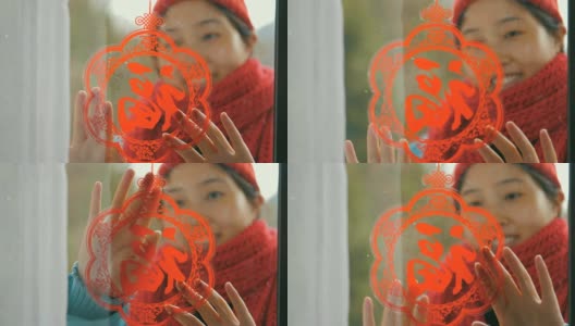 妇女把中国传统剪纸贴在窗户上高清在线视频素材下载