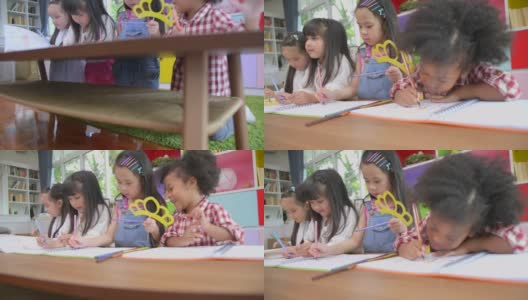 一群多元化的孩子在家庭学校的桌子上玩耍和画画，儿童多元化教育理念，国际学校，倾斜拍摄。高清在线视频素材下载