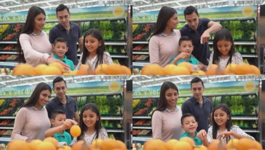 爱的儿子和女儿在超市挑选水果，而爸爸和妈妈赞成高清在线视频素材下载