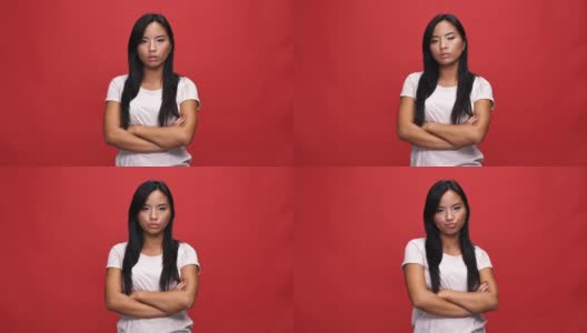 不高兴的亚洲女人在t恤，抱着交叉的双臂不同意的事情高清在线视频素材下载