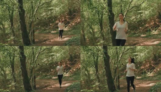 越野跑步。一个穿着运动服的心不在焉的女人在森林里慢跑。缓慢的运动。有氧运动训练和健康生活方式的概念高清在线视频素材下载