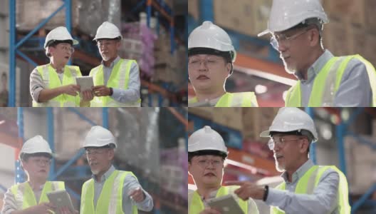 亚洲华人管理人员在仓库里讨论，穿着白色安全帽反光服，使用数码平板电脑高清在线视频素材下载