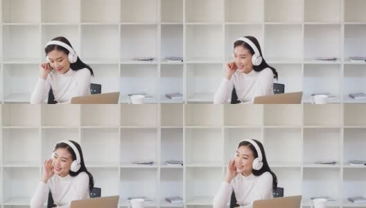 亚洲女性戴着耳机在笔记本电脑上听音乐。放松的时间。高清在线视频素材下载