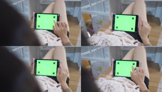 女人在用绿色屏幕的平板电脑高清在线视频素材下载