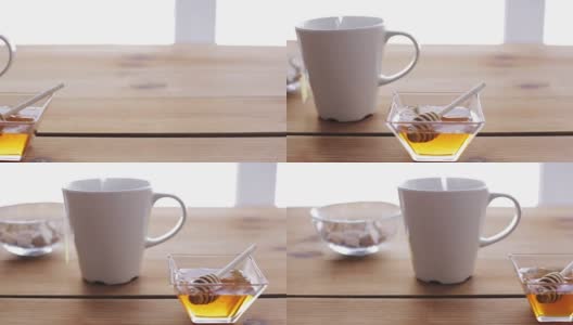 将热水倒入装有茶包和蜂蜜的杯子中高清在线视频素材下载