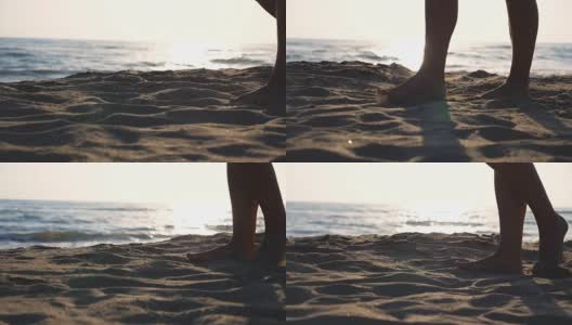 近距离的女性的脚走在金色的沙滩与海浪的背景。年轻女子的双腿踩在沙子上。光着脚的女孩在海边。暑假或假日概念。慢动作低角度视图侧视图高清在线视频素材下载