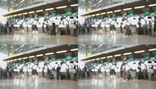 模糊画面显示，国际机场航站楼的乘客走向值机柜台。带有散焦效果的4K视频。高清在线视频素材下载