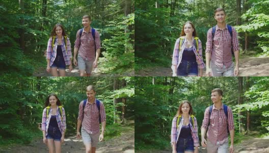 一个男人和一个女人走在树林里，在移动中交流，在行进中度过美好的时光高清在线视频素材下载