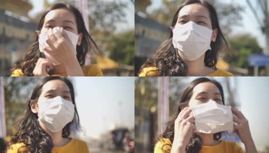 年轻的亚洲妇女咳嗽与面罩保护高清在线视频素材下载