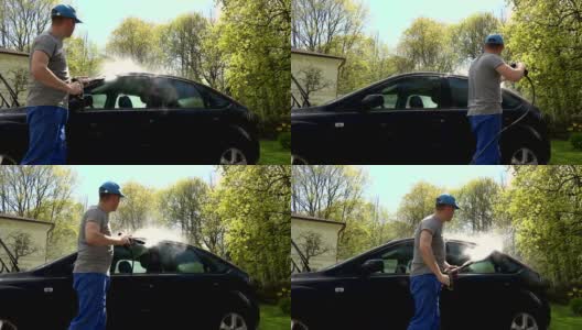 伙计，用高压水喷雾器冲洗他的车高清在线视频素材下载