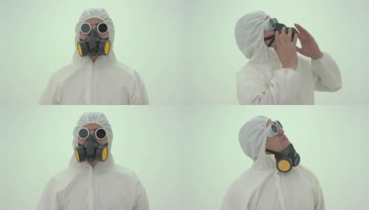 一个穿着白色化学防护服的男人的特写镜头和降下的防毒面具打开他的头向右，并把他的面具戴上。过了一会儿，他又摘下了面具高清在线视频素材下载