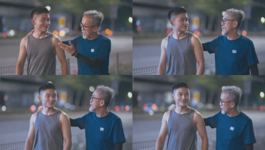亚洲华人活跃的老人和他的儿子在晚上一起跑步锻炼后散步聊天城市高清在线视频素材下载