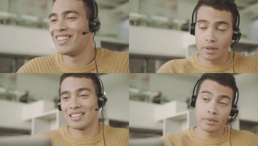 微笑英俊的拉丁裔男子通过头戴耳机的视频连接与客户沟通高清在线视频素材下载