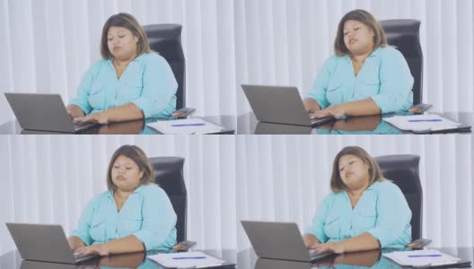 超重的女商人在办公室里看起来睡着了高清在线视频素材下载