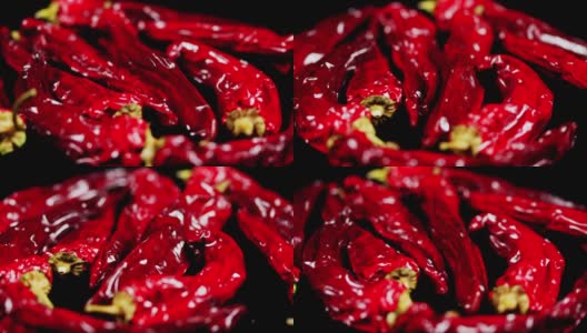 在黑色背景上的红色干辣椒。又辣又干的泰国红辣椒高清在线视频素材下载