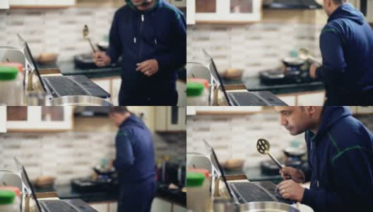 中年男人在厨房做饭。高清在线视频素材下载