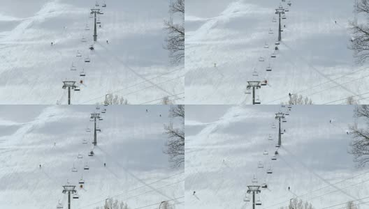 人们在冬季滑雪场的雪坡上滑雪和滑板。雪山上的滑雪电梯。冬季滑雪胜地的活动高清在线视频素材下载