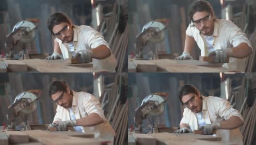 木匠木材厂车间桌子上工人用砂纸摩擦木材的特写。做手工的帅哥。高清在线视频素材下载