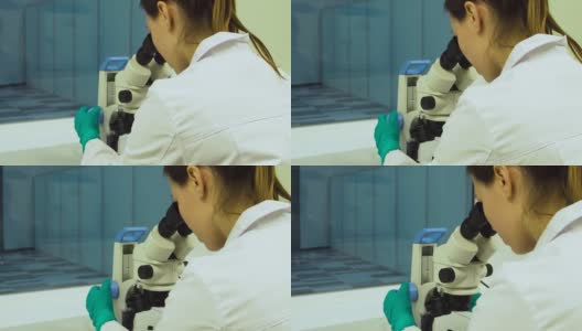 女医生在显微镜下观察高清在线视频素材下载