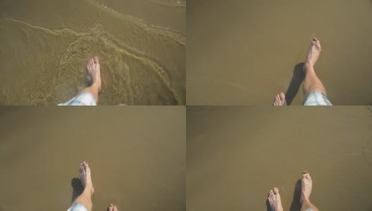 一个男人的腿走在浅水上，走在沙滩上高清在线视频素材下载