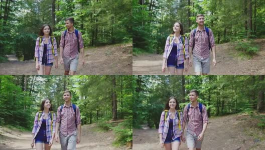 一对背着背包的年轻游客在树林里散步。温暖的夏天高清在线视频素材下载
