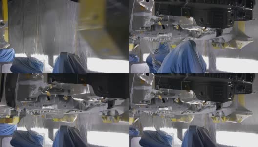在汽车工厂里，机器人正在车身喷漆，在auto下移动高清在线视频素材下载