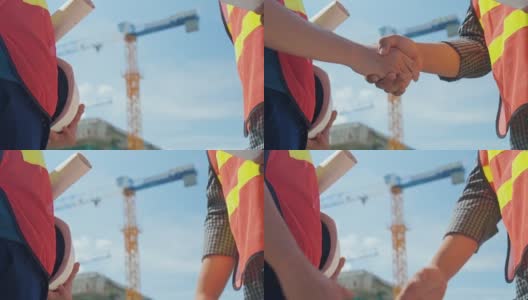 两个工程师在建筑工地握手，慢镜头高清在线视频素材下载