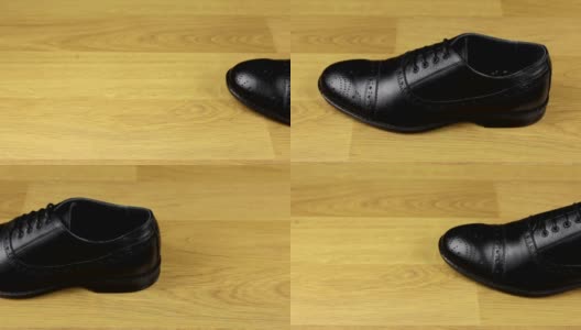 优雅的男式鞋带鞋立在木地板上。滑动条。高清在线视频素材下载
