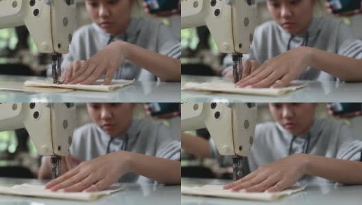 亚洲华裔女时装大学生在大学工作坊做服装缝纫项目高清在线视频素材下载