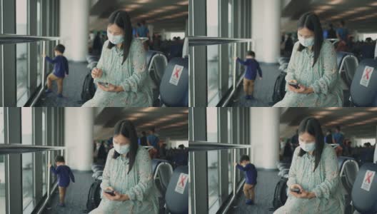 女旅客在机场候机时使用手机。高清在线视频素材下载
