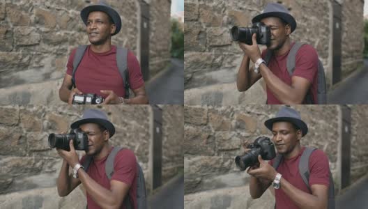 非洲快乐的游客用他的单反相机拍照。在欧洲旅行的年轻人高清在线视频素材下载