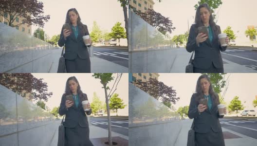 千禧一代的职业女商人正用手机走在城市街道上高清在线视频素材下载