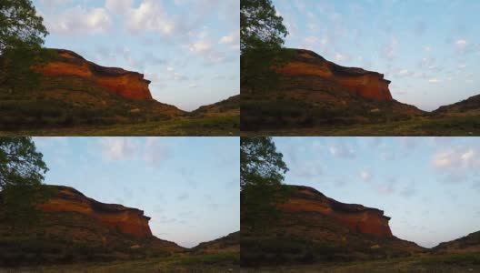在雄伟的金门高地国家公园的岩石悬崖上的日落移动云，南非。时间流逝的视频。高清在线视频素材下载