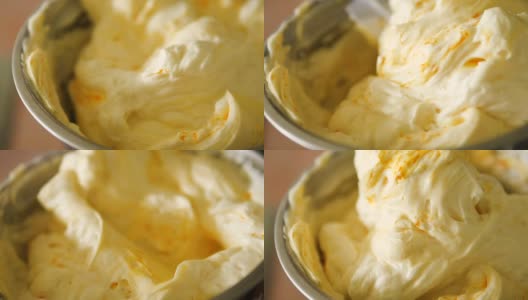 将黄色和蛋糕奶油混合，慢动作。高清在线视频素材下载