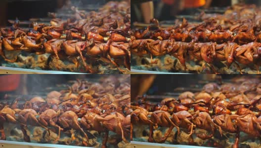 慢动作镜头的特写烹饪烤鸽子的传统烤架，泰国传统食物，亚洲食物高清在线视频素材下载