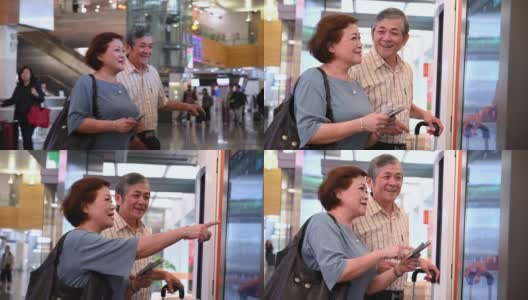 一对老年夫妇正在查询机场起飞信息高清在线视频素材下载